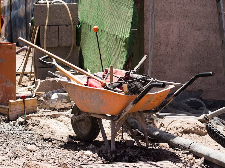 Construction site with wheelbarrow filled with tools