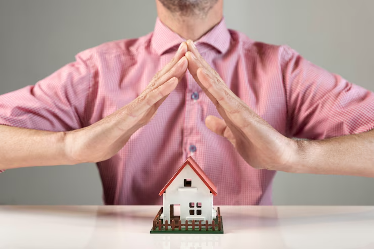 Person creating roof of house with hands concept