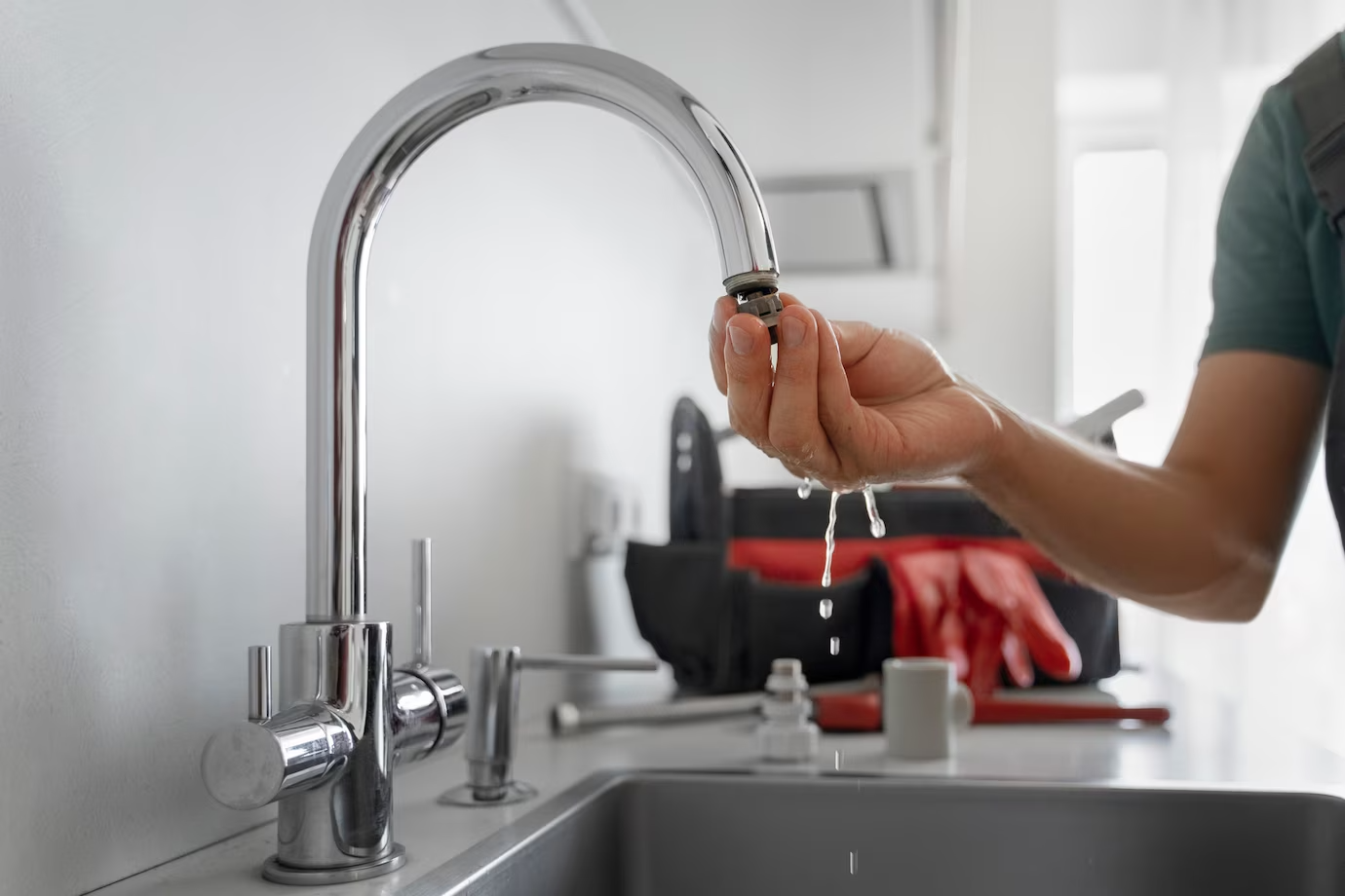 Side view of a plumber working on home plumbing repairs