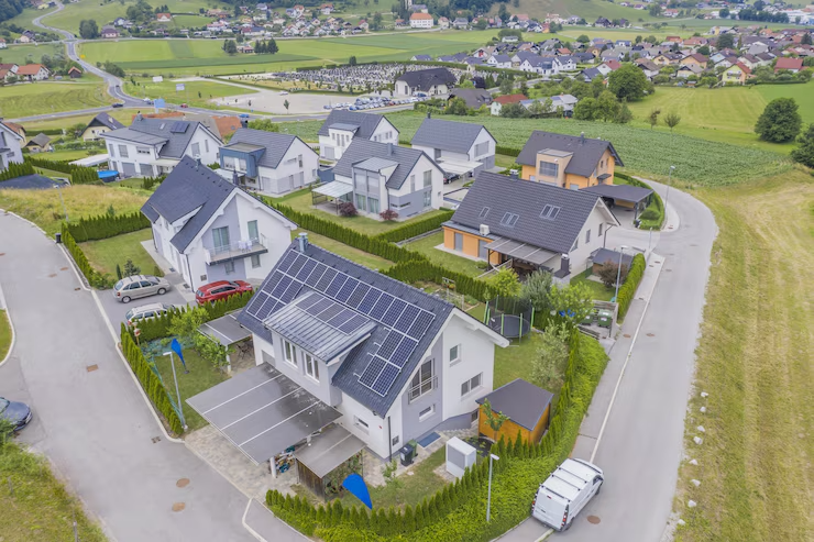Neighborhood homes with solar panels on multiple roofs