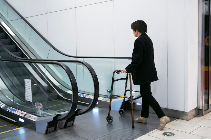 Adult using a walking frame near home escalators